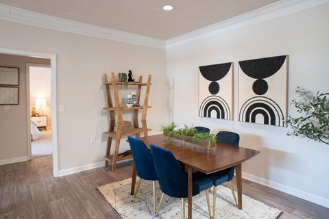 a dining room with a wooden table and blue chairs